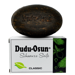 Dudu-Osun® CLASSIC - Black soap from Africa, a natural and organic soap bar. The product features a dark, oval-shaped soap with the brand name "Dudu-Osun" printed on it. The packaging displays the "Bio" (organic) certification and the "Sehr gut" (very good) rating from the Öko-Test consumer organization.