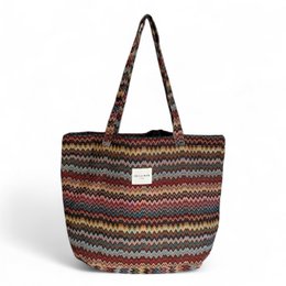  Large multicolored striped tote bag with woven texture and handles.