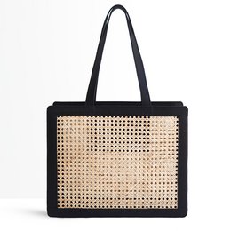 A black handbag with a woven straw pattern and gold-tone hardware. The bag has a rectangular shape and a structured silhouette, making it suitable for both casual and formal occasions.