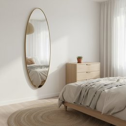 Large oval gold steel mirror, 50x170 cm, for wall decor in modern, minimalist style.