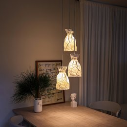 Crinkle paper pendant lamp with a modern, minimalist design. Features a warm, ambient lighting effect.