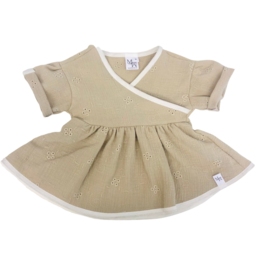 A beige baby dress with a wrap-around design and short sleeves. The dress features a simple, minimalist style that is suitable for everyday wear.