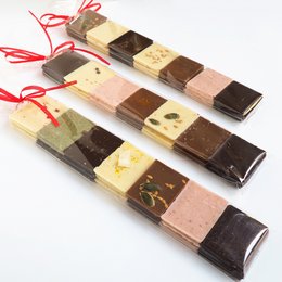 Assorted chocolate gift box with various flavors and textures, including dark chocolate, milk chocolate, and white chocolate pieces.
