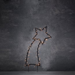 A tall, black metal garden plug with warm white LED lighting in the shape of a shooting star. The plug measures 35 cm in length and 77 cm in height.