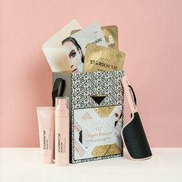 This beauty gift set includes a variety of products in a stylish, patterned box. The set contains items such as makeup brushes, lipstick, and other cosmetic items, making it a perfect gift for pampering and self-care.