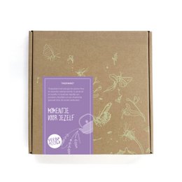 Lavender-themed tea package with a wooden spoon, tea bags, and a lavender-themed tea tin. The package includes the text "Moment for yourself" and features a lavender floral design.