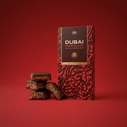  Dark chocolate bar with speculoos and kunafa flavors, geometric pattern packaging, premium gift box.