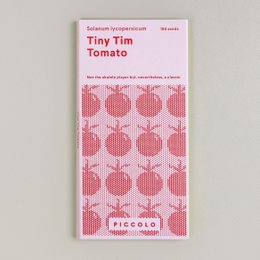 Small, round, red tomatoes on a green plant with leaves.