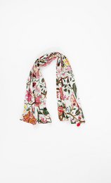 Floral patterned cotton scarf in white, pink, and green tones. Features a whimsical, fantasy-inspired design with various flowers, leaves, and abstract shapes.