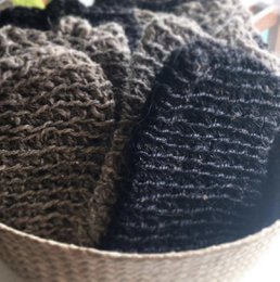  Exfoliating glove made from natural goat hair, with a textured, ribbed design for effective skin cleansing.