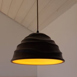 A hanging lamp with a dark brown exterior and a golden interior, featuring a tiered dome-shaped shade. The lamp has a wooden base and a gold/black cable, and is suitable for a 230V/50Hz E27 (max 10W LED) socket.