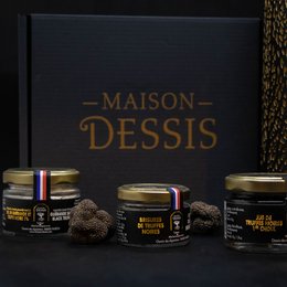A gift box containing gourmet truffles from Maison Dessis, featuring a dark, elegant design with the brand name prominently displayed.