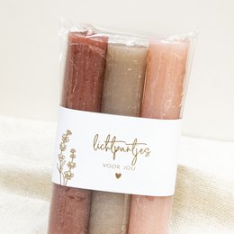  Set of 3 tall, round candles in shades of red and pink. Ideal for creating a warm, cozy ambiance in any room.