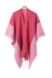 Pink and red color-block wool poncho keychain with draped asymmetrical design and soft texture.