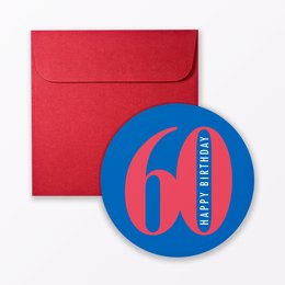 A round, red birthday card with the number "60" printed on it, along with the text "happy birthday" in blue. The card is accompanied by a blue and red circular sticker or label.