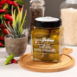 Green olives stuffed with almonds, 314 ML, canned vegetables. Olive green jar with black lid, filled with green olives and almonds.