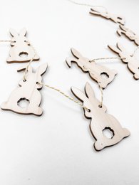 Wooden Easter bunny garland featuring a string of carved wooden bunny shapes in a natural finish, perfect for seasonal home decor.