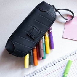 Black pencil case with tire-inspired design, suitable for storing school or office supplies.