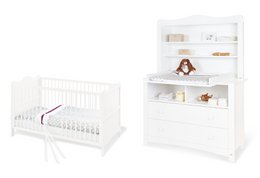 White crib, changing unit, and extra wide shelf unit in a nursery room with natural light and wooden accents.
