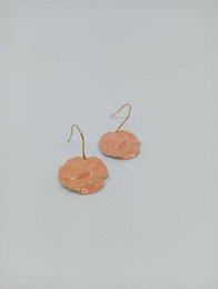  Peach-colored enamel drop earrings with a round, disc-shaped design.