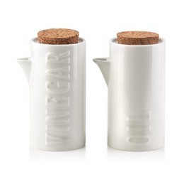 A set of two white ceramic oil and vinegar bottles with cork lids. The bottles have a modern, minimalist design and can hold 0.2L of liquid each.