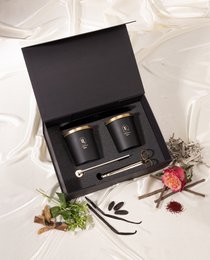  Black cylindrical scented candles with gold lid, luxury gift set, floral botanical design, premium packaging.