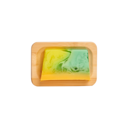 Rectangular bamboo soap holder with two soap bars in natural colors.