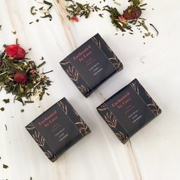 Dark chocolate tea boxes with floral accents, containing 10 grams of tea.