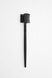 Black double-sided eyebrow and eyelash grooming brush with firm bristles.