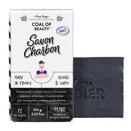 A natural face and body soap made with charcoal, suitable for beard care. The soap is black in color and comes in a box with a vintage-style design.