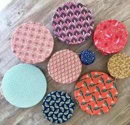 Large, adaptable food wraps in a variety of colorful, patterned designs including floral, geometric, and abstract motifs.