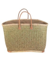 A woven straw shopping bag with leather handles. The bag has a rectangular shape and a natural, earthy color palette.