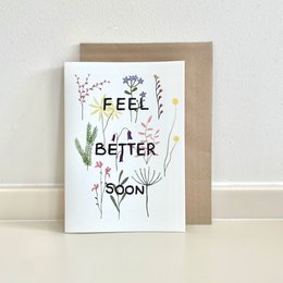 Colorful floral card with the text "Feel Better Soon" surrounded by various flowers and plants.