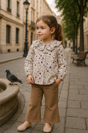 Grease Long Sleeve Blouse, a kids' shirt featuring a floral print in shades of pink, purple, and white. The blouse has a loose, flowing silhouette and long sleeves.