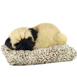  Soft, plush pug puppy toy in beige and black colors, resting on a textured surface. The product is described as a "PLUSH WITH SOUND PUG MINI" measuring approximately 14x13x5.5cm.