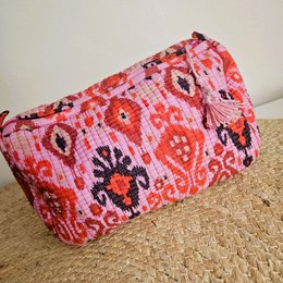  Large pink and red floral patterned toiletry bag made of blockprint fabric.
