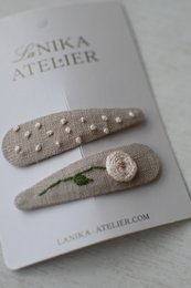Beige hair clips with rose and dot patterns, suitable for hair accessories.