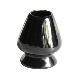 Black ceramic matcha whisk holder with a sleek, tapered design.
