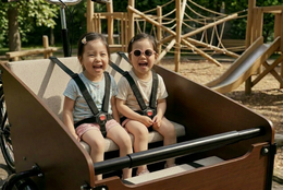 Beige linen cushion for bakfiets cargo bike, soft textile padding, neutral color home decor accessory.