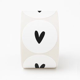White stickers with a black heart design, sold in a roll of 250.