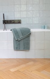  Large, soft, absorbent shower towel in various neutral colors.