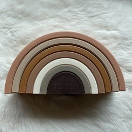 Neutral-toned rainbow-shaped stacking toy made of wood, suitable for babies and toddlers.