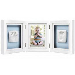  A white wooden frame with three compartments - one for a photo and two for handprint or footprint impressions. The frame is designed for displaying a baby's photo and keepsake impressions.