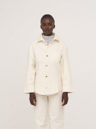  Cream fitted denim over shirt with button closure, suitable for women's casual or formal wear.