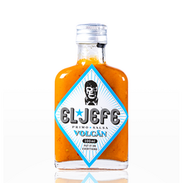 Spicy orange-colored hot sauce in a glass bottle with a label featuring a portrait illustration.