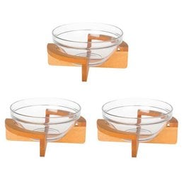 "Joy Kitchen salad bowl on wooden base - A round, glass salad bowl with a wooden base. The bowl is clear and the base is a natural wood color."
The image shows a round, clear glass salad bowl sitting on a wooden base. The bowl appears to be made of glass and the base is made of a natural-colored wood. This product would be suitable for serving salads or other dishes in an elegant, rustic-style kitchen or dining setting.