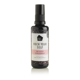 A self-love and confidence-boosting essential oil spray in a black bottle with a white label that reads "Rock Your Self".