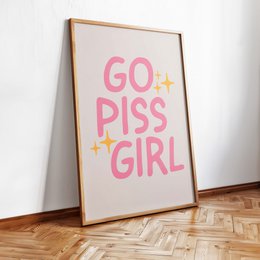  A bold and empowering poster with the text "GO PISS GIRL" in vibrant pink and yellow colors, displayed in a simple wooden frame against a white background.