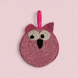 'Organic cotton cuddle cloth with a hand-crocheted owl design in vibrant pink. The round, plush cloth features large eyes and a distinctive owl shape, perfect for comforting and soothing young children.'