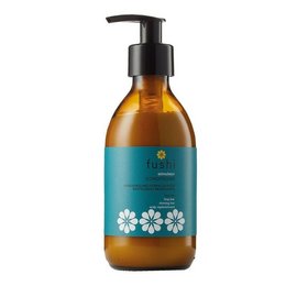 Herbal conditioner with floral design, amber-colored bottle, pump dispenser. Suitable for hair care.